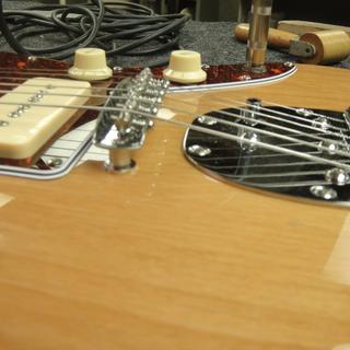 Tilting the neck increases the bridge break angle.  This is too much for the pickups