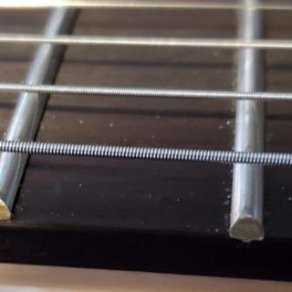 The frets are installed inconsistently vis a vis the edge of the fretboard.