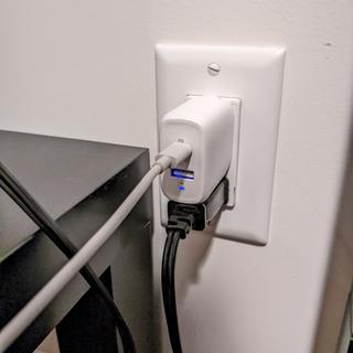Plugged into a wall outlet. Note how there's still enough room for another outlet below.