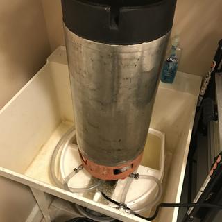 Keg cleaner in action in laundry room sink.